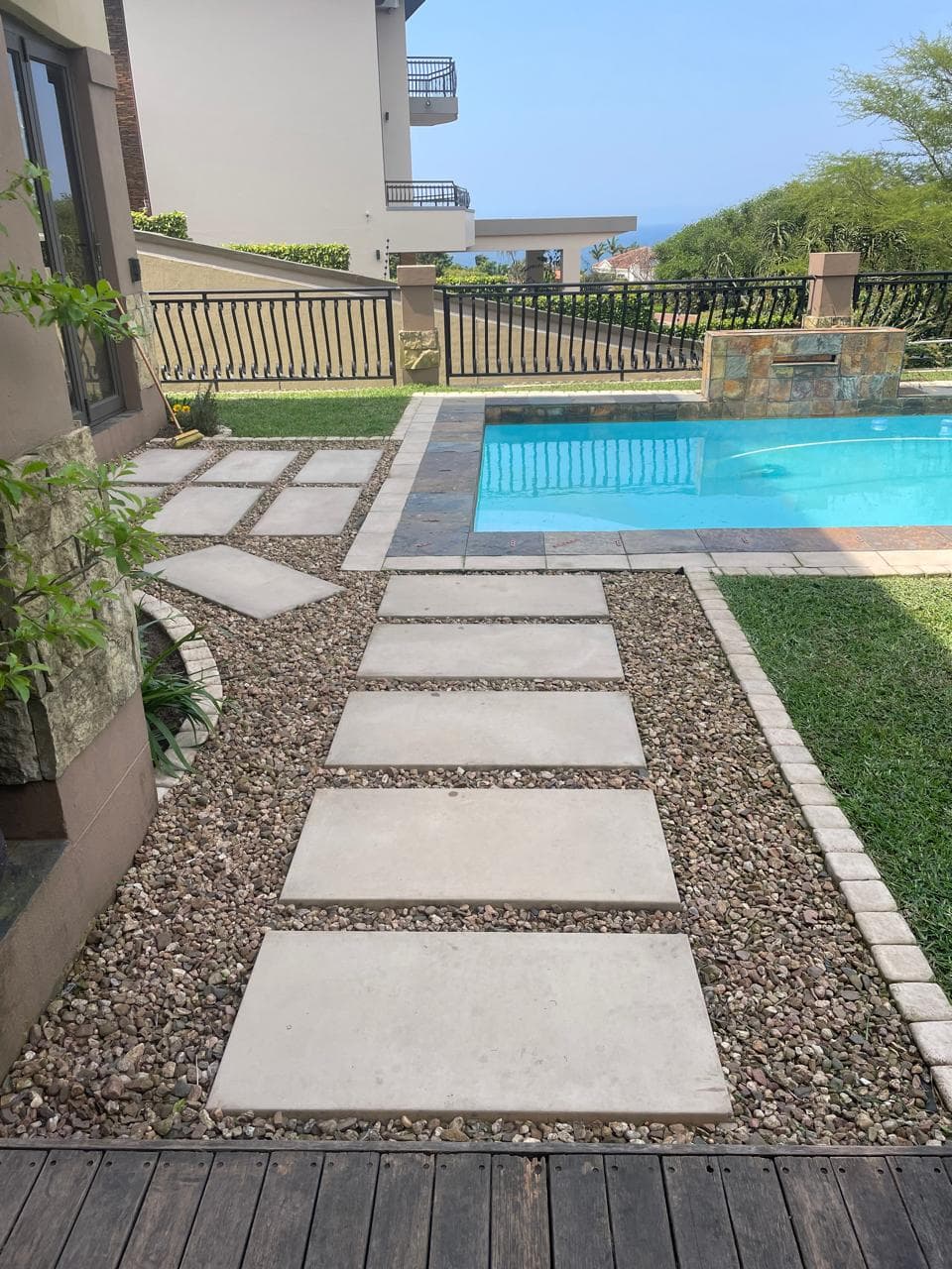 Stepping stone pathway with gravel leading to pool area